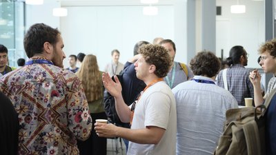 Attendees chatting during a coffee break at TartanQEC 2026, Informatics Forum, University of Edinburgh