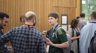 Attendees chatting during a coffee break at TartanQEC 2026, Informatics Forum, University of Edinburgh