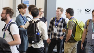 Attendees chatting during registration and coffee at TartanQEC 2026, Informatics Forum, University of Edinburgh